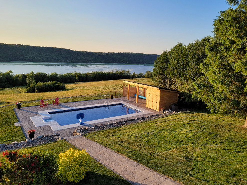 Inspiration for a backyard concrete paver and rectangular pool house remodel
