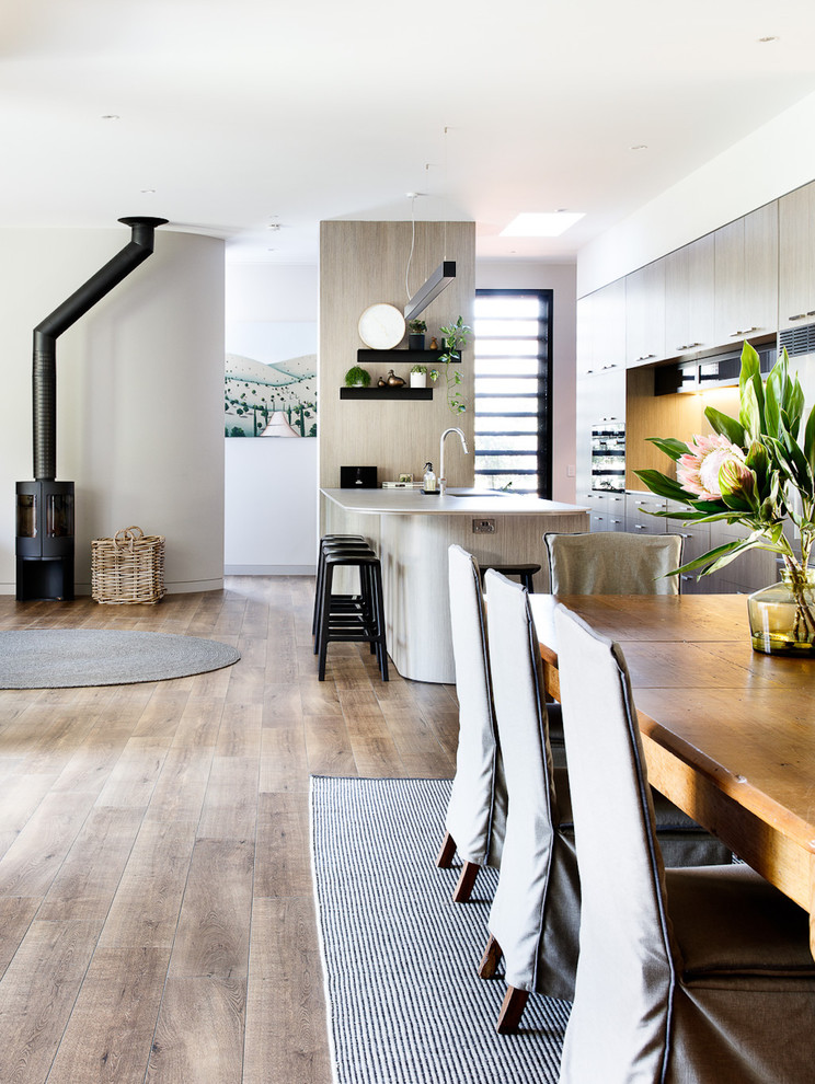 Inspiration for a mid-sized contemporary open plan dining in Melbourne with beige walls, medium hardwood floors and brown floor.