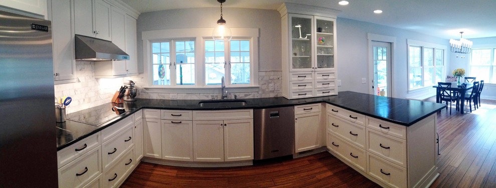Kitchen - transitional u-shaped kitchen idea in Raleigh with shaker cabinets, white cabinets and stainless steel appliances