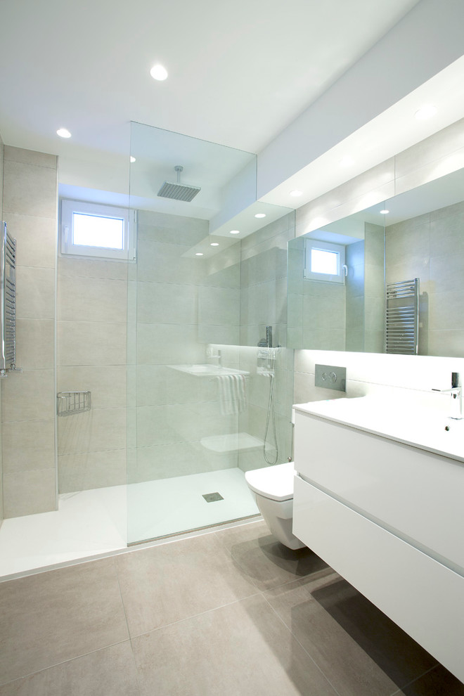 Mid-sized contemporary master bathroom in Other with flat-panel cabinets, white cabinets, a curbless shower, a wall-mount toilet, multi-coloured walls, ceramic floors and an integrated sink.