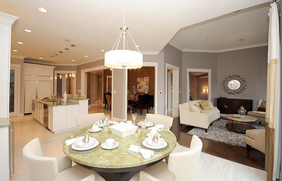 Photo of a mid-sized traditional open plan dining in Edmonton with grey walls, porcelain floors and beige floor.