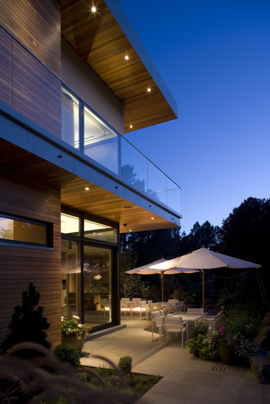 This is an example of a large contemporary two-storey brown exterior in Denver with wood siding.