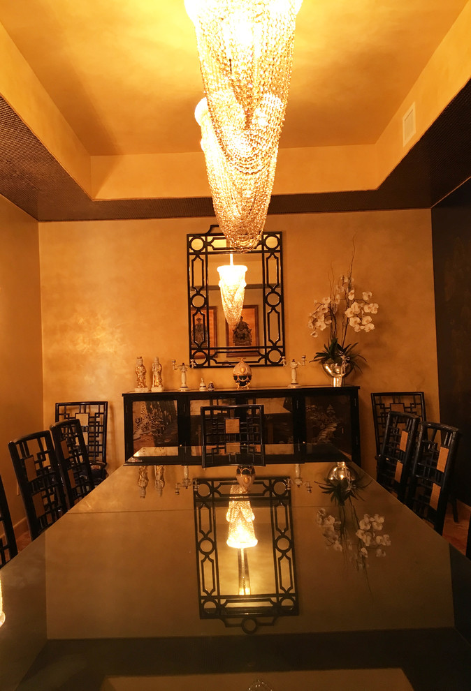 Design ideas for a large asian separate dining room in Miami with black walls and marble floors.