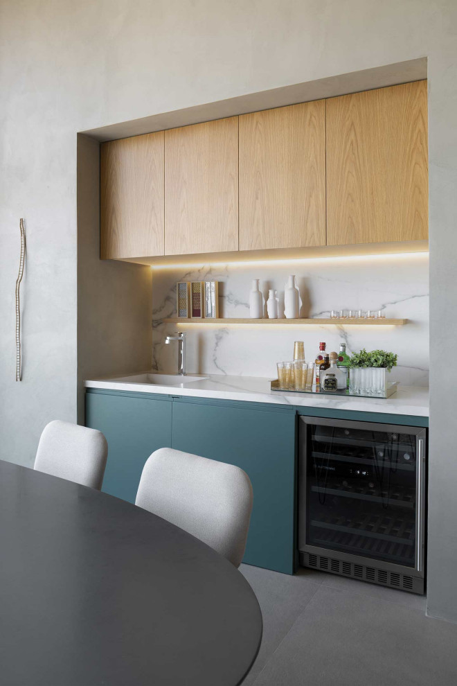 Inspiration for a small contemporary single-wall wet bar in Nancy with an integrated sink, flat-panel cabinets, blue cabinets, grey splashback, grey floor and grey benchtop.