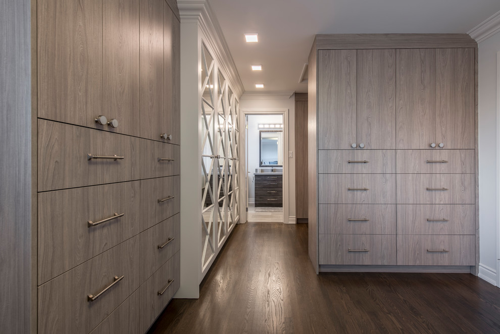 Photo of a large contemporary women's walk-in wardrobe in Toronto with flat-panel cabinets, medium wood cabinets, medium hardwood floors and brown floor.