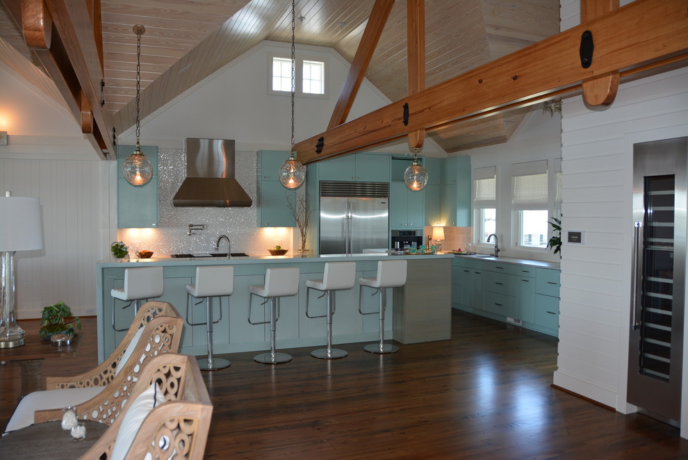 Inspiration for a large l-shaped light wood floor enclosed kitchen remodel in Orange County with an undermount sink, flat-panel cabinets, blue cabinets, solid surface countertops, white backsplash, porcelain backsplash, stainless steel appliances and an island