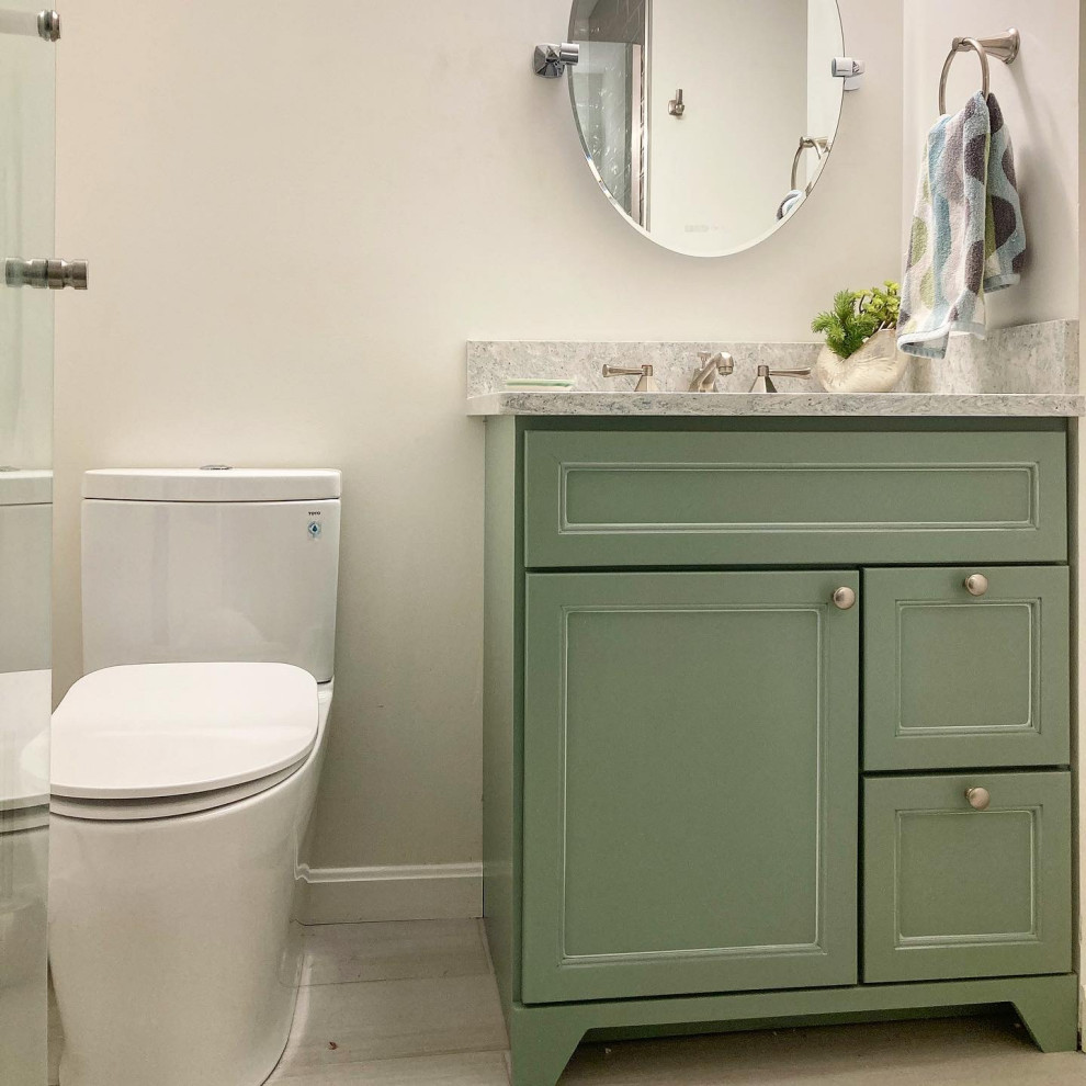 Inspiration for a medium sized beach style shower room bathroom in Boston with shaker cabinets, green cabinets, an alcove shower, a bidet, grey tiles, glass tiles, green walls, porcelain flooring, a submerged sink, engineered stone worktops, grey floors, a hinged door, blue worktops, a single sink and a freestanding vanity unit.