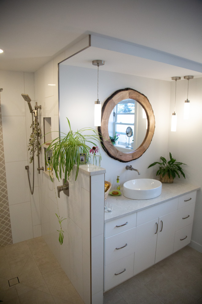 Photo of a medium sized contemporary ensuite bathroom in Edmonton with flat-panel cabinets, white cabinets, an alcove bath, a built-in shower, a wall mounted toilet, multi-coloured tiles, porcelain tiles, white walls, porcelain flooring, a vessel sink, quartz worktops, beige floors, an open shower, white worktops, a wall niche, a single sink and a built in vanity unit.
