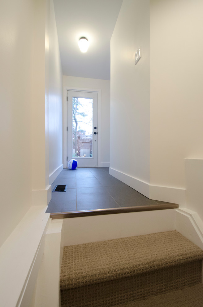 Basement - mid-sized transitional look-out laminate floor and beige floor basement idea in Toronto with white walls