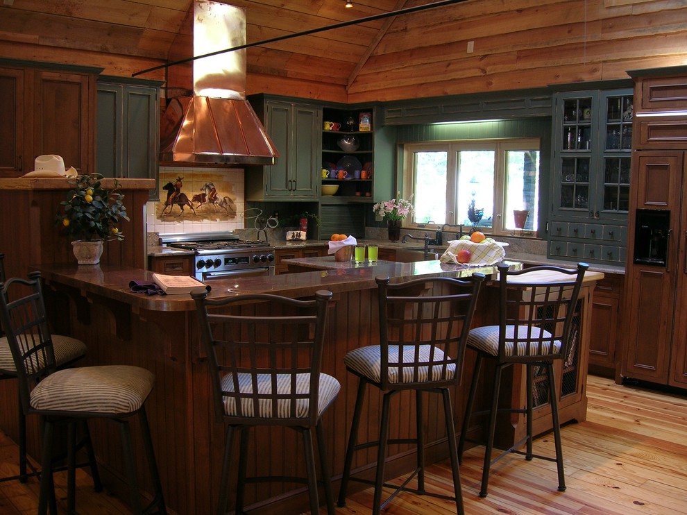 This is an example of a country l-shaped eat-in kitchen in Other with beaded inset cabinets, green cabinets, copper benchtops, mosaic tile splashback, stainless steel appliances and a farmhouse sink.