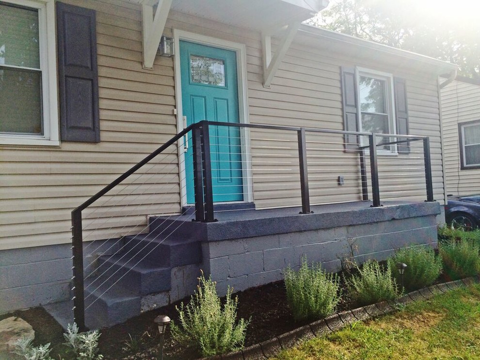 This is an example of a small transitional front yard verandah in Seattle with concrete slab.