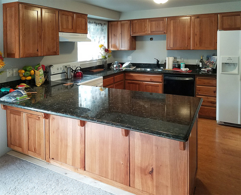 Example of a large u-shaped brown floor kitchen design with shaker cabinets and no island