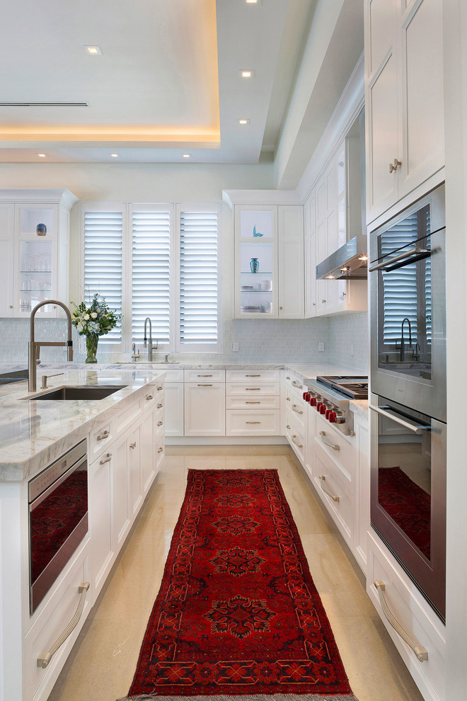 Example of a mid-sized transitional l-shaped ceramic tile and beige floor open concept kitchen design in Miami with an undermount sink, recessed-panel cabinets, white cabinets, marble countertops, multicolored backsplash, mosaic tile backsplash, stainless steel appliances, an island and multicolored countertops
