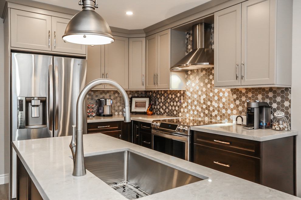 Enclosed kitchen - mid-sized transitional l-shaped porcelain tile enclosed kitchen idea in Toronto with an undermount sink, recessed-panel cabinets, gray cabinets, quartz countertops, gray backsplash, mosaic tile backsplash, stainless steel appliances and an island