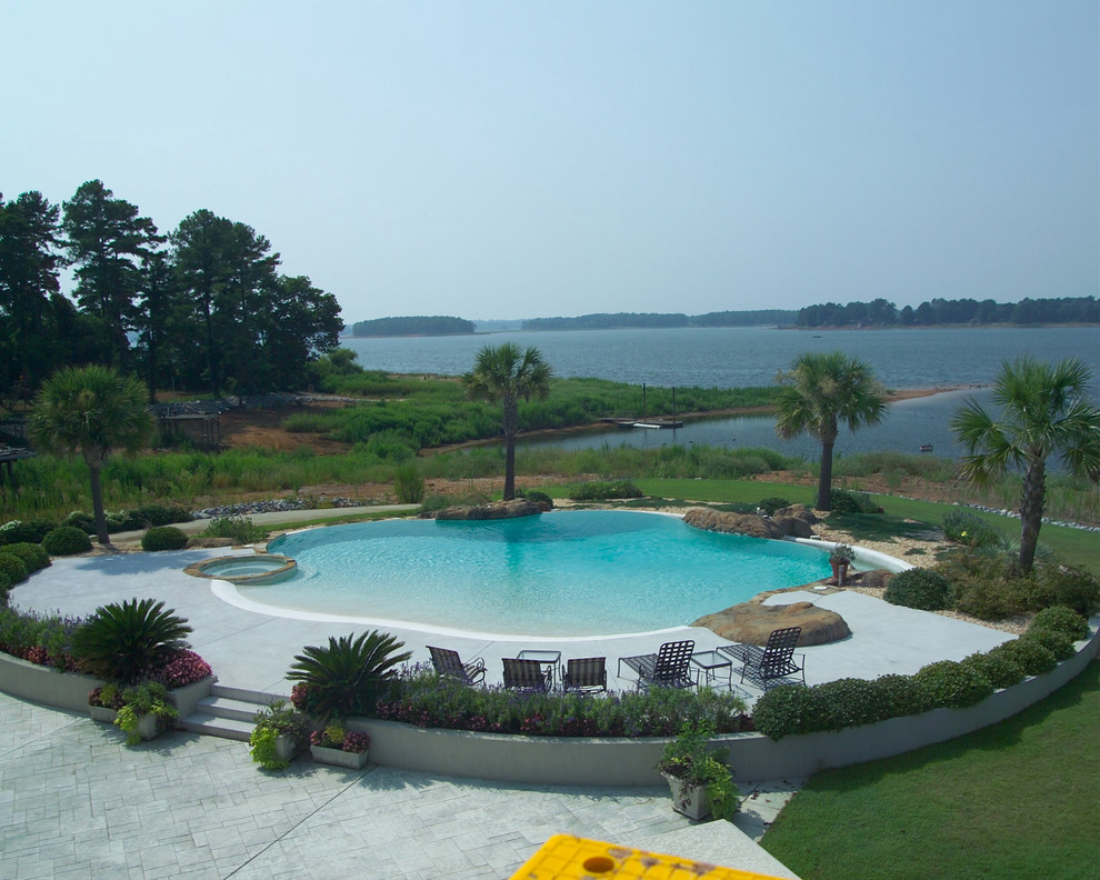 Inspiration for a large coastal backyard concrete and custom-shaped natural hot tub remodel in Other