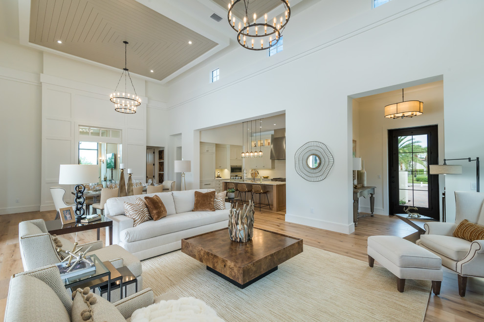 This is an example of a transitional living room in Miami with white walls, medium hardwood floors and brown floor.