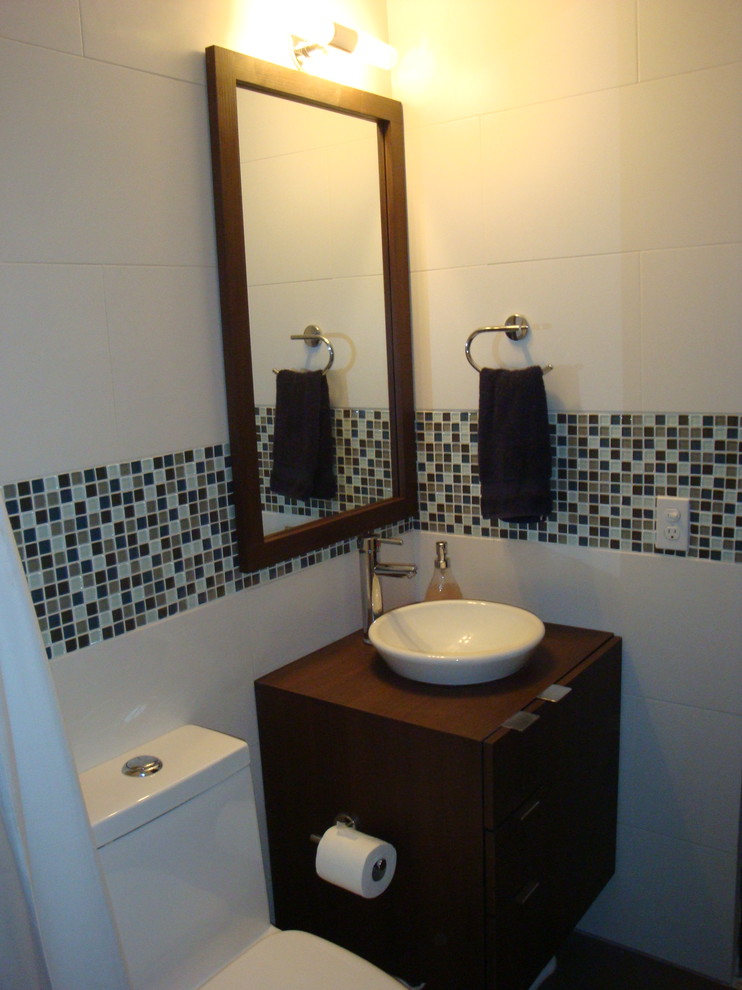 Small contemporary master bathroom in Other with a vessel sink, flat-panel cabinets, dark wood cabinets, laminate benchtops, a one-piece toilet, white tile, porcelain tile, white walls and porcelain floors.