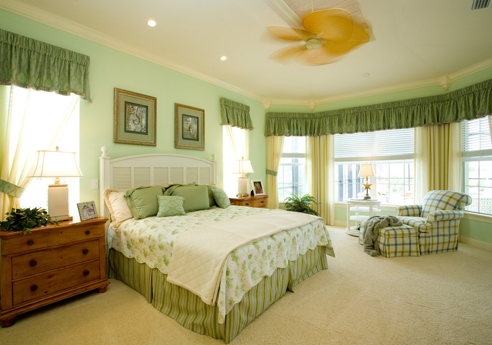 Photo of a traditional bedroom in Miami with green walls, carpet and no fireplace.
