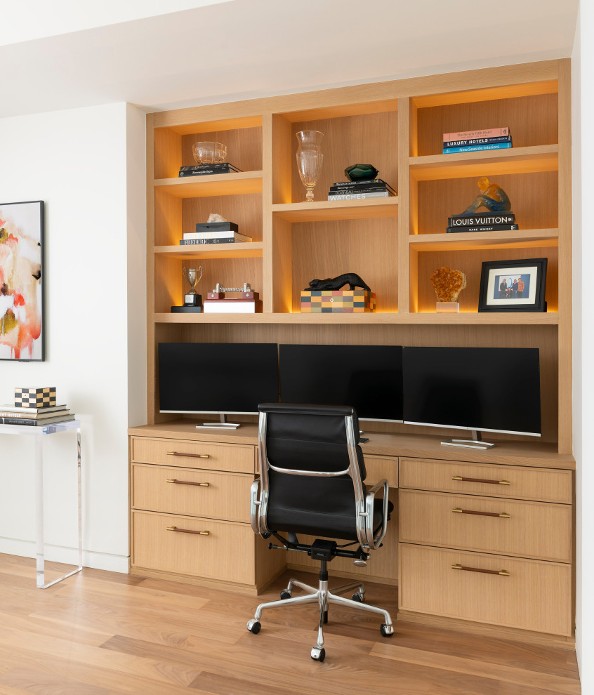 Example of a mid-sized trendy built-in desk light wood floor and beige floor study room design in Dallas with white walls