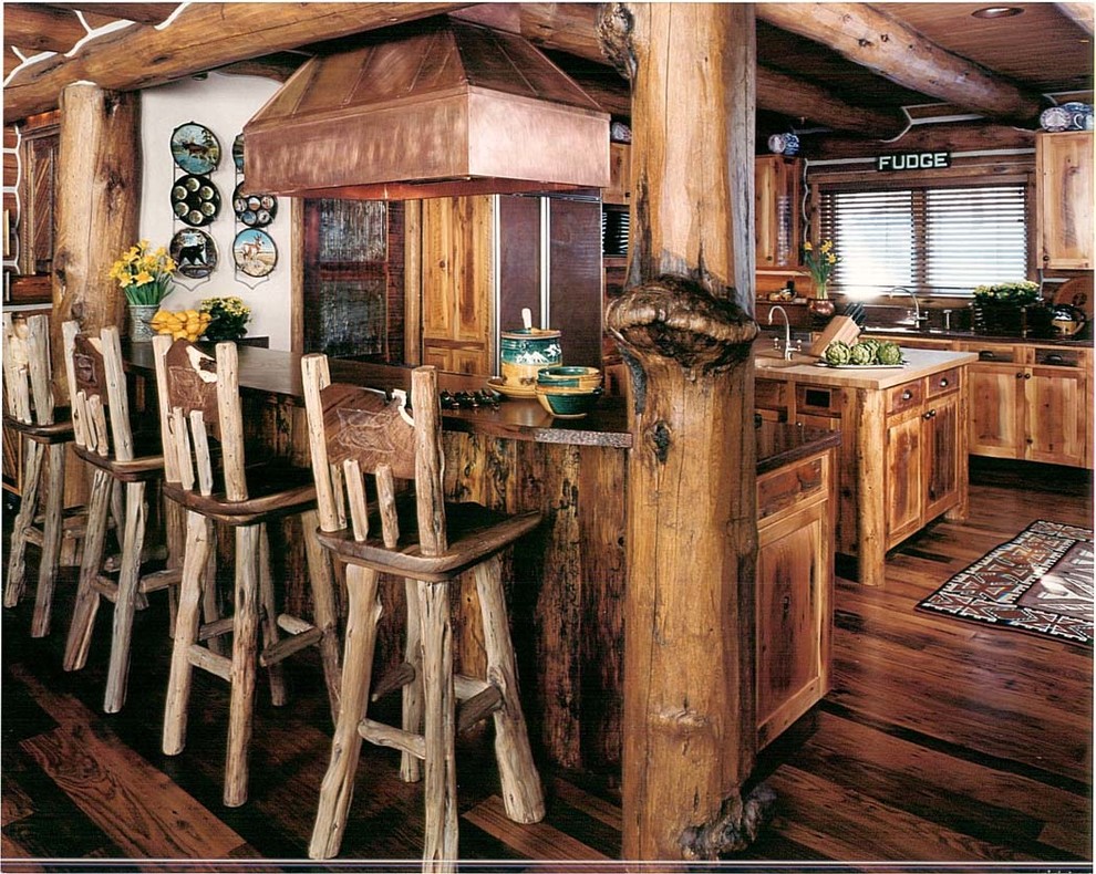 Example of a mountain style u-shaped medium tone wood floor eat-in kitchen design with a double-bowl sink, shaker cabinets, paneled appliances and an island