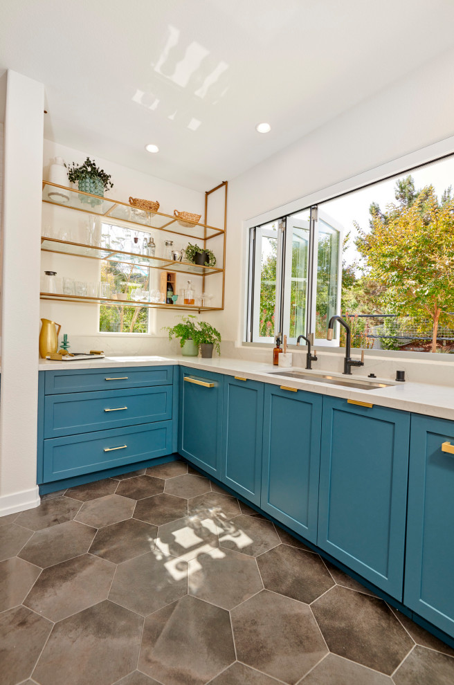 Photo of a large midcentury u-shaped open plan kitchen in Denver with an undermount sink, recessed-panel cabinets, green cabinets, quartz benchtops, white splashback, ceramic splashback, stainless steel appliances, porcelain floors, with island, grey floor and white benchtop.