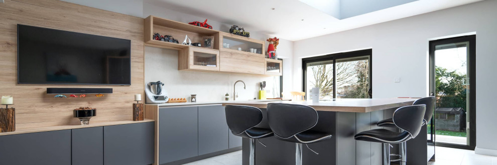 Large minimalist single-wall home bar photo in Hertfordshire with flat-panel cabinets, gray cabinets and concrete countertops