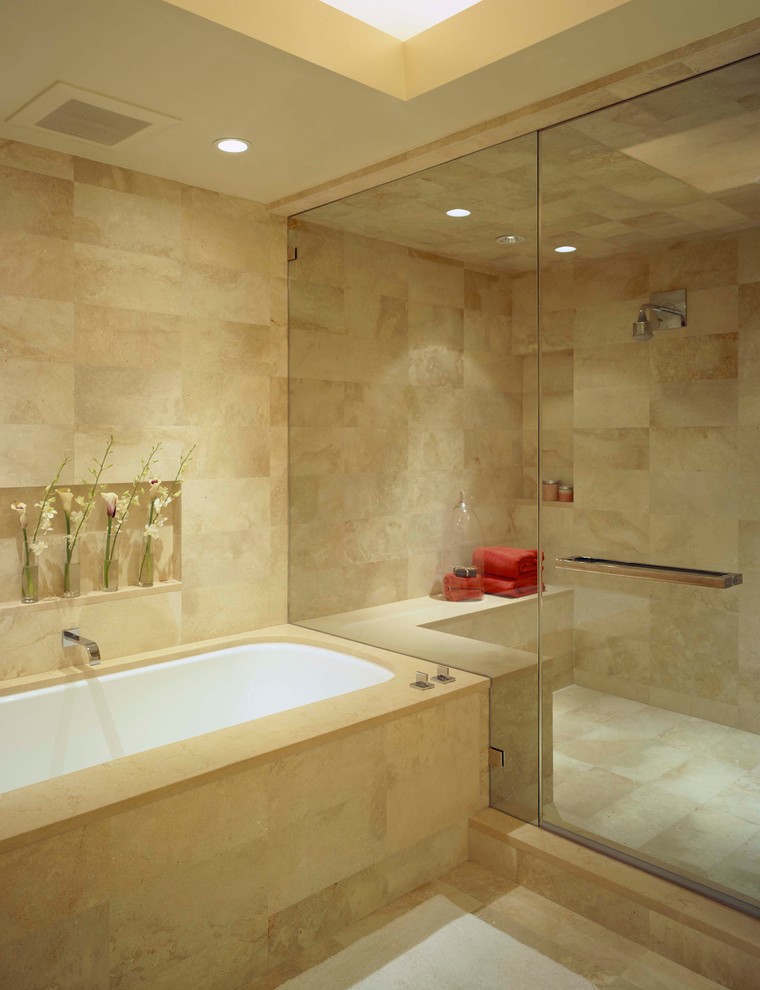 Photo of a contemporary bathroom in San Francisco with an undermount tub, an alcove shower, beige tile, a hinged shower door and travertine.