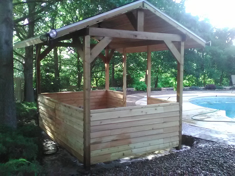 Example of a mid-sized mountain style backyard stone full sun shed design for summer