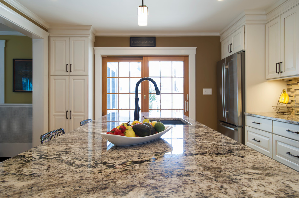 Inspiration for a mid-sized transitional galley light wood floor eat-in kitchen remodel in Boston with an undermount sink, raised-panel cabinets, white cabinets, granite countertops, multicolored backsplash, ceramic backsplash, stainless steel appliances and an island
