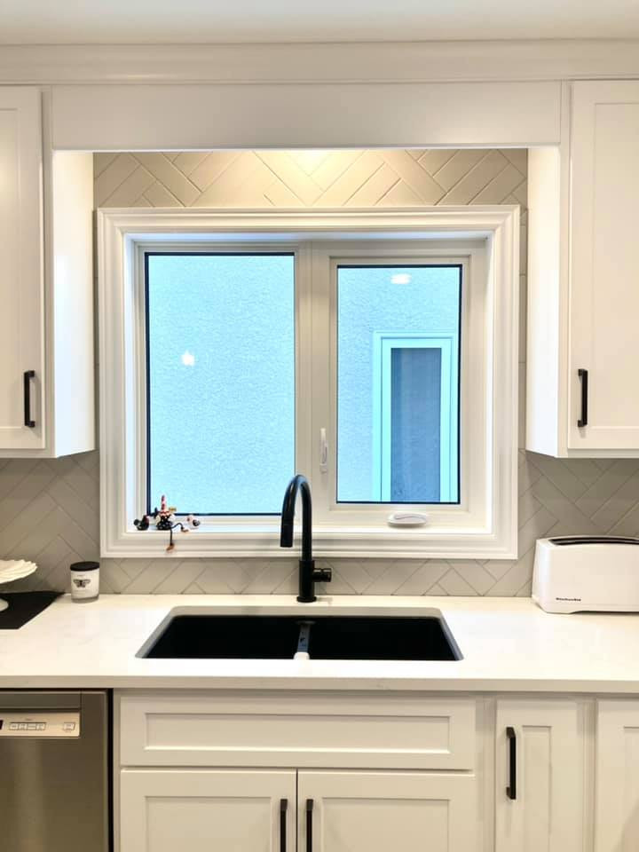 Inspiration for a mid-sized transitional galley ceramic tile and gray floor enclosed kitchen remodel with a double-bowl sink, shaker cabinets, white cabinets, quartz countertops, gray backsplash, ceramic backsplash, stainless steel appliances, an island and white countertops