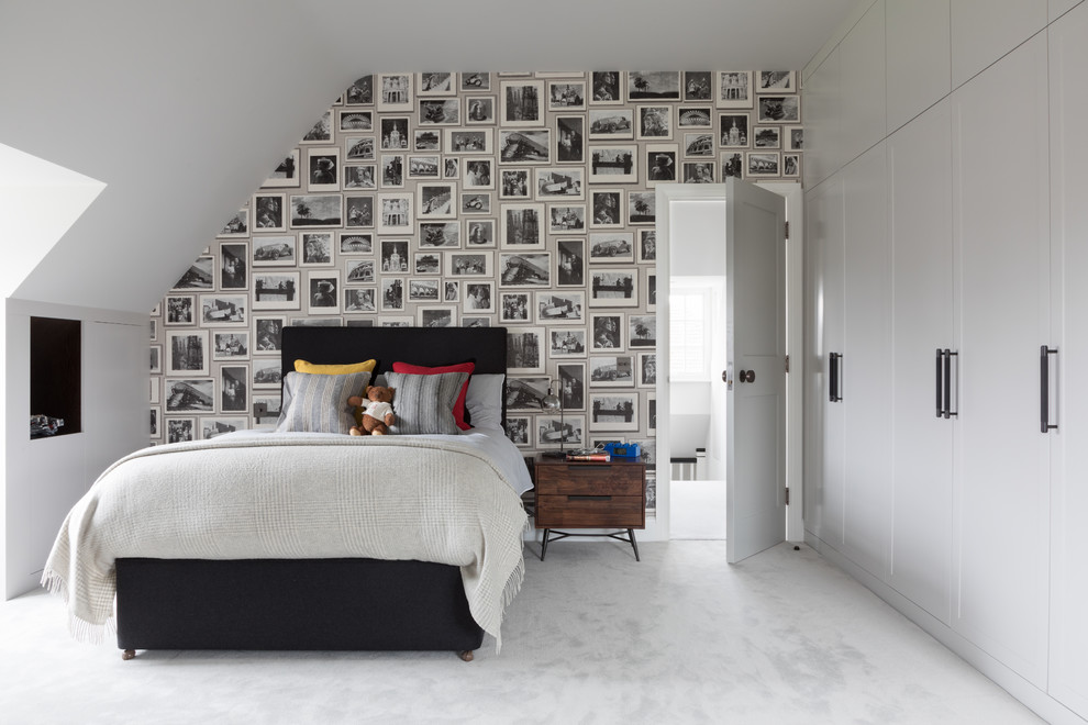 Inspiration for a mid-sized transitional gender-neutral kids' bedroom for kids 4-10 years old in London with white walls, carpet and grey floor.
