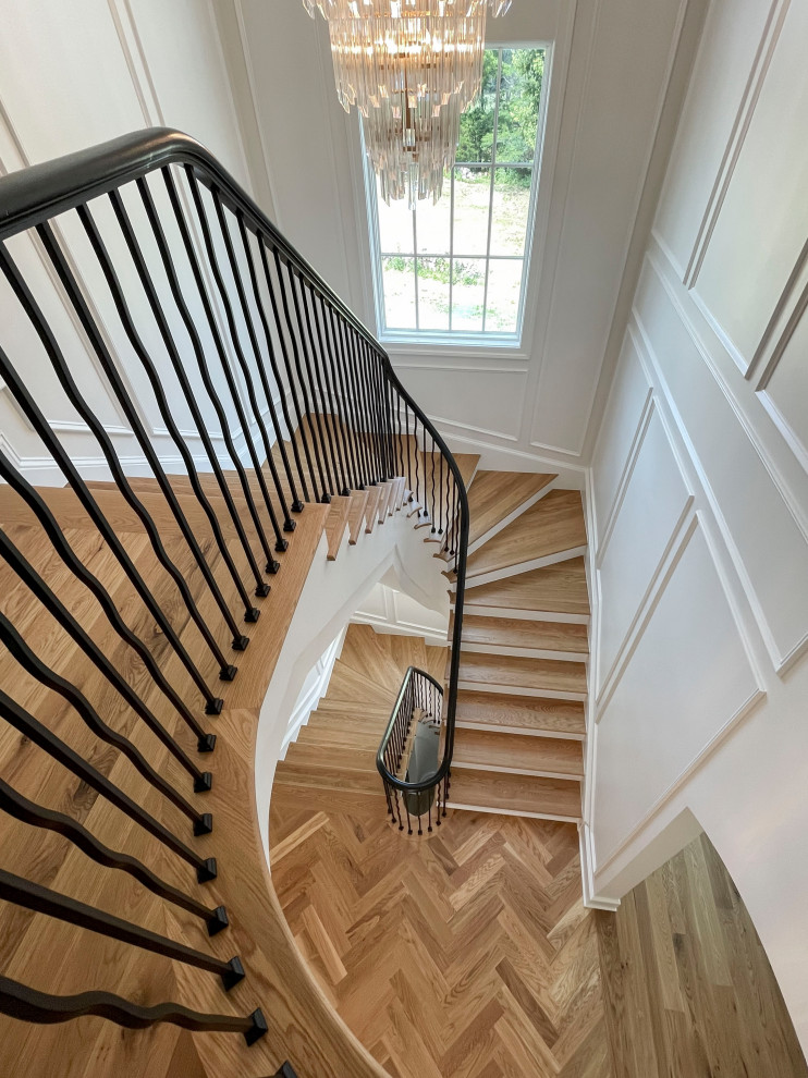 Large transitional wood floating staircase in DC Metro with painted wood risers, mixed railing and decorative wall panelling.