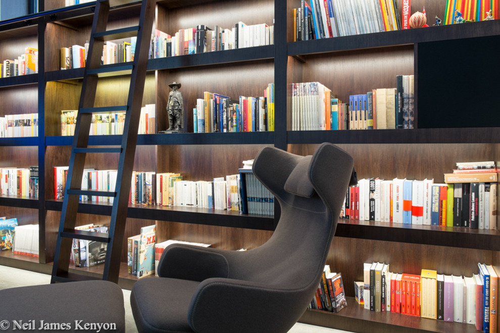 This is an example of a mid-sized home office in London with a library, ceramic floors and a freestanding desk.