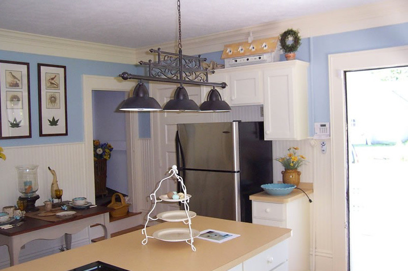 Inspiration for an eat-in kitchen remodel in Cleveland with a double-bowl sink, recessed-panel cabinets, white cabinets, granite countertops and a peninsula