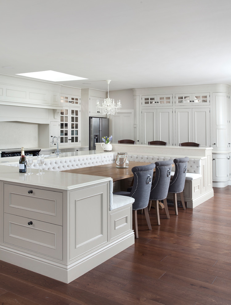 Photo of a large traditional eat-in kitchen in Other with shaker cabinets and white cabinets.
