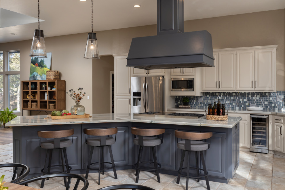 Inspiration for a huge ceramic tile and beige floor open concept kitchen remodel in Other with an undermount sink, raised-panel cabinets, blue cabinets, quartzite countertops, multicolored backsplash, glass tile backsplash, stainless steel appliances, an island and gray countertops