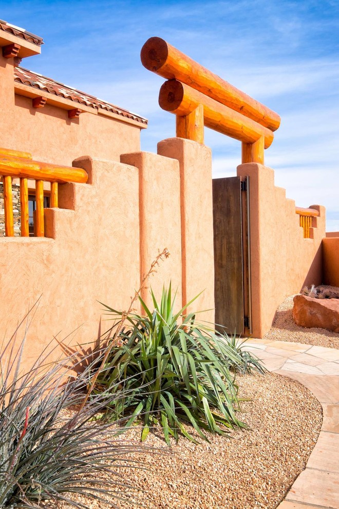 Design ideas for a mid-sized one-storey adobe brown exterior in Albuquerque with a flat roof.