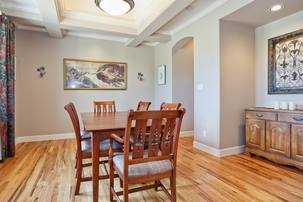 Photo of a mediterranean dining room in Denver with light hardwood floors.