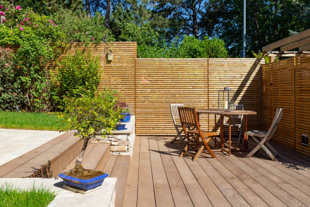 Inspiration for a mid-sized transitional front yard full sun garden for summer in Paris with decking.