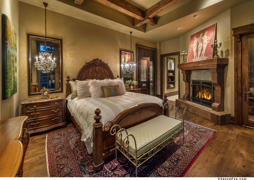 Design ideas for a country master bedroom in Sacramento with beige walls, medium hardwood floors, a standard fireplace and a wood fireplace surround.