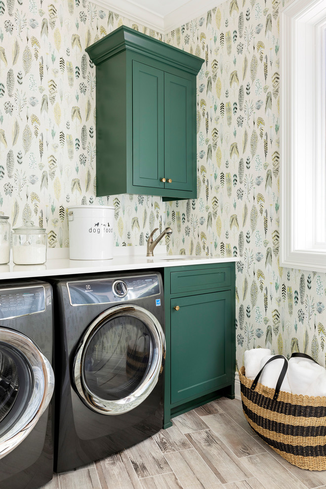 Photo of a small beach style dedicated laundry room in Minneapolis with green cabinets, quartzite benchtops, multi-coloured walls, ceramic floors, a side-by-side washer and dryer, beige floor, white benchtop and shaker cabinets.