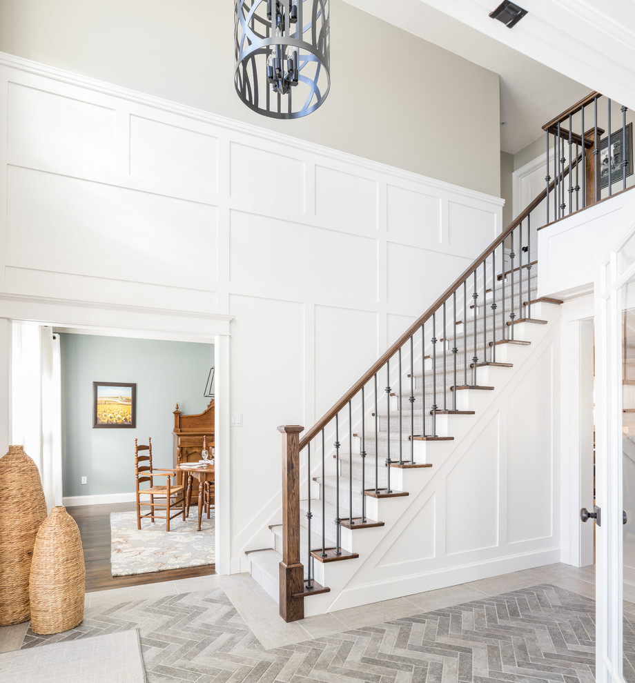 Design ideas for an expansive traditional foyer in Toronto with white walls, ceramic floors, a single front door, a black front door and grey floor.