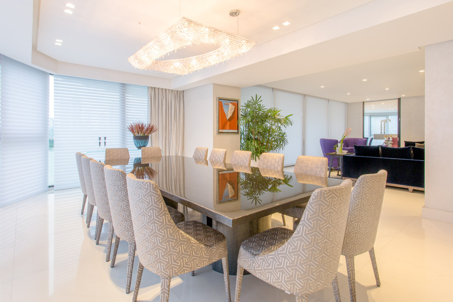 Large contemporary open plan dining in Miami with white walls, limestone floors, no fireplace and white floor.