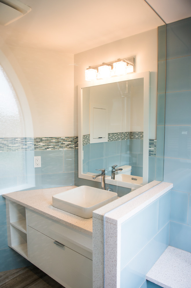 Mid-sized transitional master bathroom in Toronto with flat-panel cabinets, white cabinets, an open shower, blue tile, mosaic tile, white walls, porcelain floors, a vessel sink, engineered quartz benchtops and a one-piece toilet.