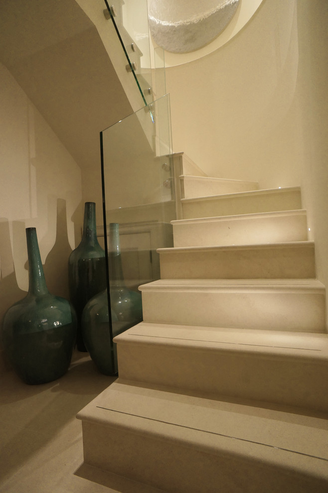 This is an example of a mid-sized transitional curved staircase in London.