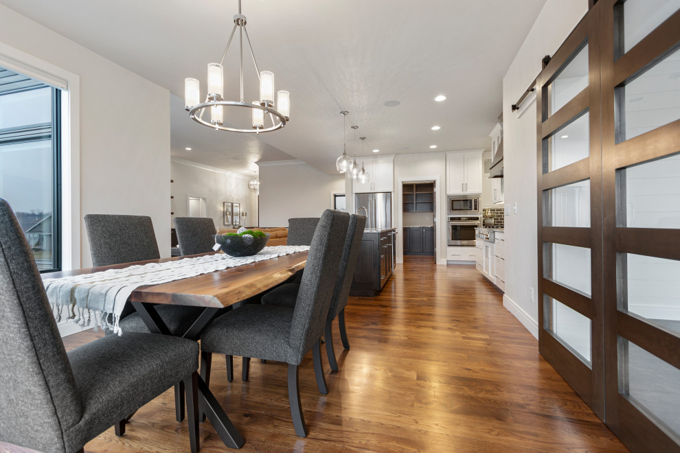 Mid-sized transitional medium tone wood floor and brown floor kitchen/dining room combo photo with white walls and no fireplace