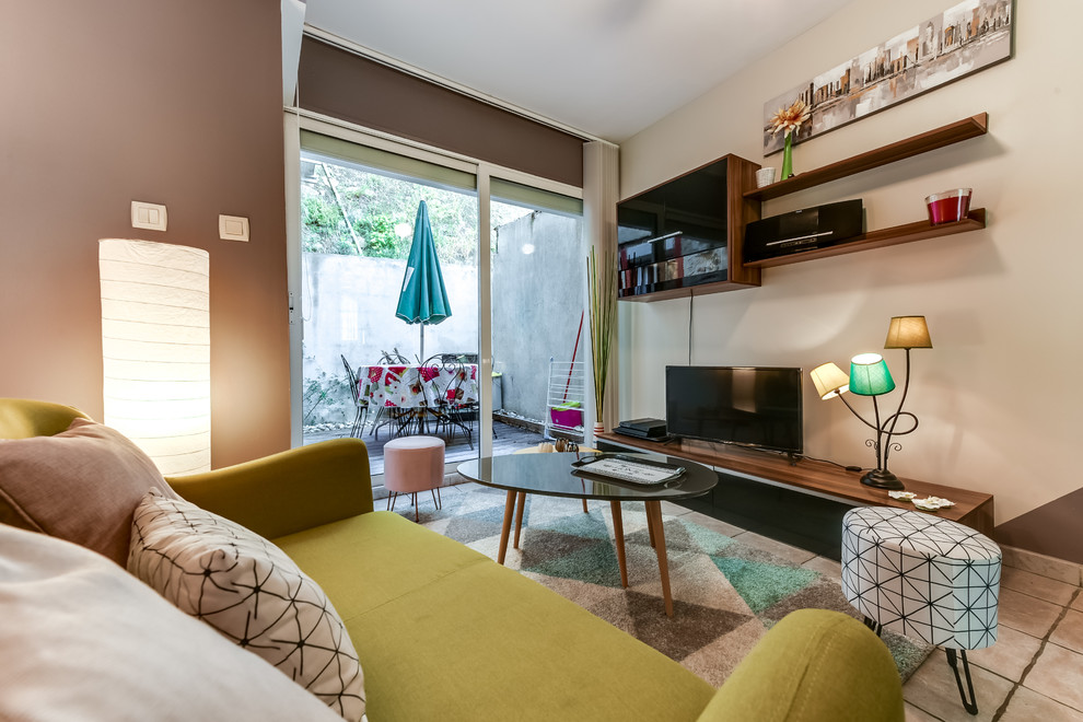 Photo of a mid-sized contemporary open concept living room in Other with multi-coloured walls, ceramic floors, no fireplace, a freestanding tv and beige floor.