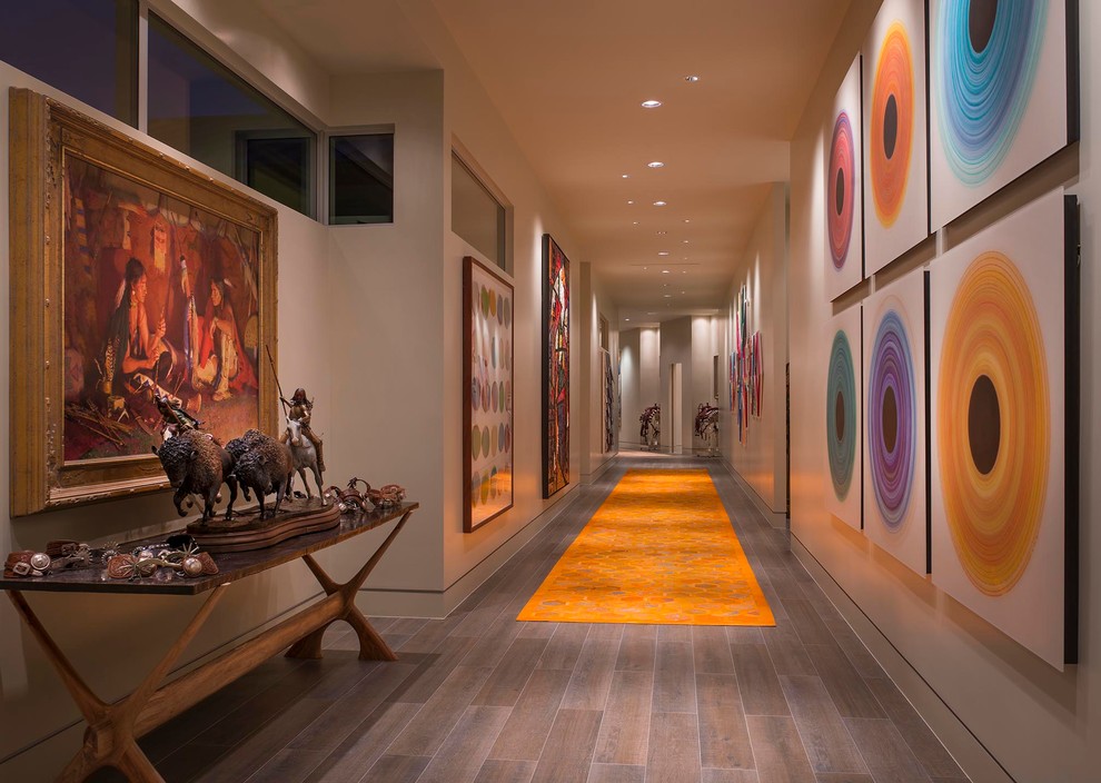 This is an example of an expansive contemporary hallway in Austin with beige walls and porcelain floors.