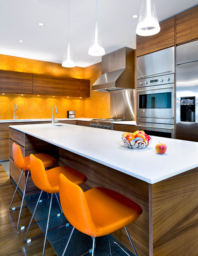 Design ideas for a contemporary l-shaped kitchen in Montreal with flat-panel cabinets, medium wood cabinets, orange splashback, stainless steel appliances, medium hardwood floors and with island.