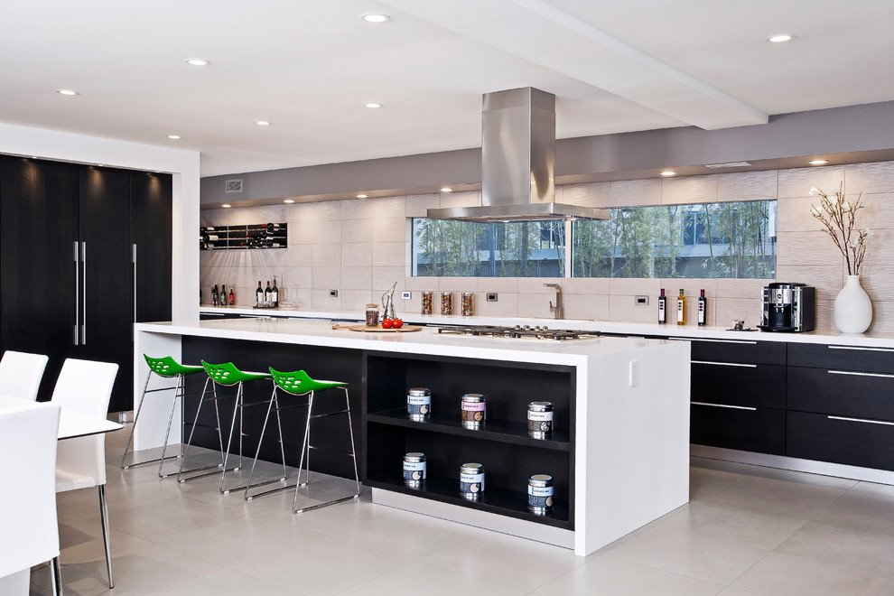 This is an example of a contemporary galley eat-in kitchen in San Francisco with flat-panel cabinets, black cabinets and beige splashback.